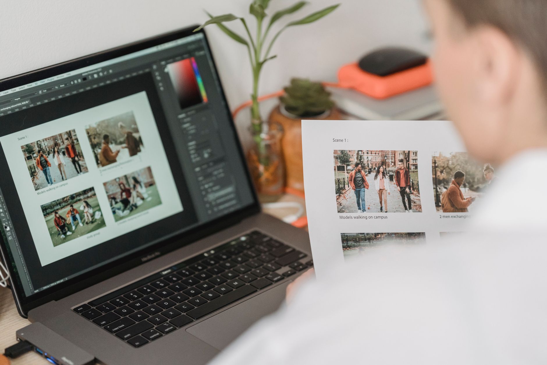 a photographer reviewing hundreds of photos on a laptop in a dim studio