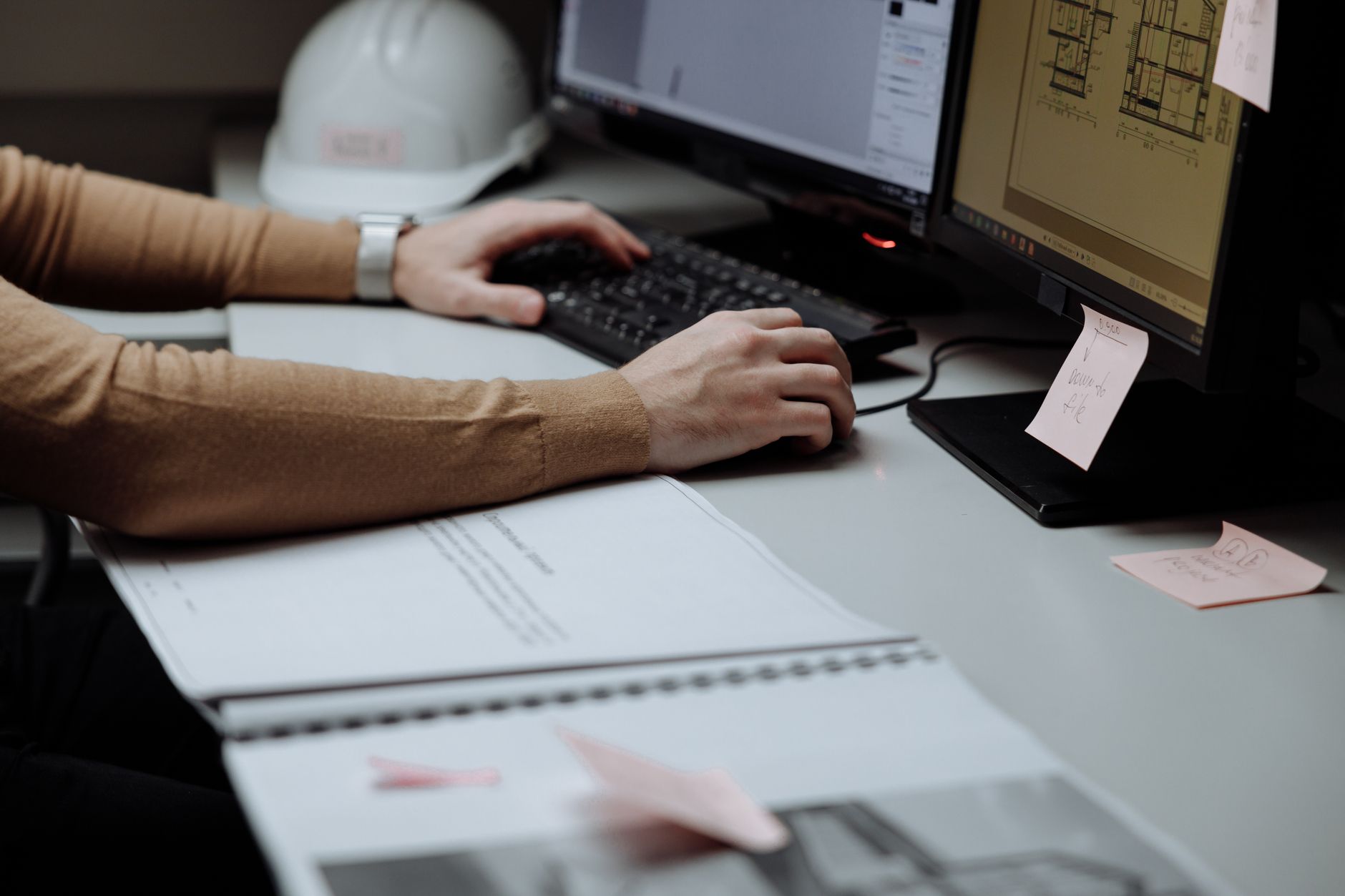 a person configuring a workflow automation on a dual monitor setup with a dashboard visible