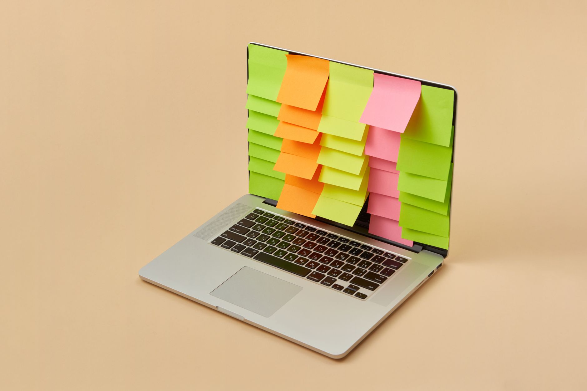 A laptop screen displaying a digital task board with cards and notes, on a tidy desk.
