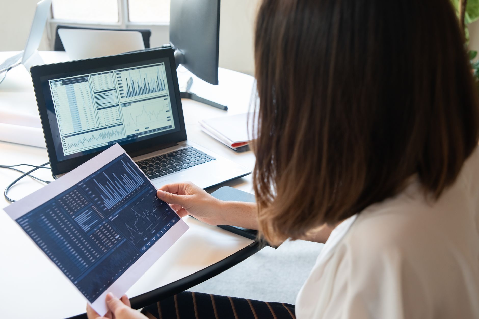 a marketer reviewing a marketing analytics dashboard on a computer screen