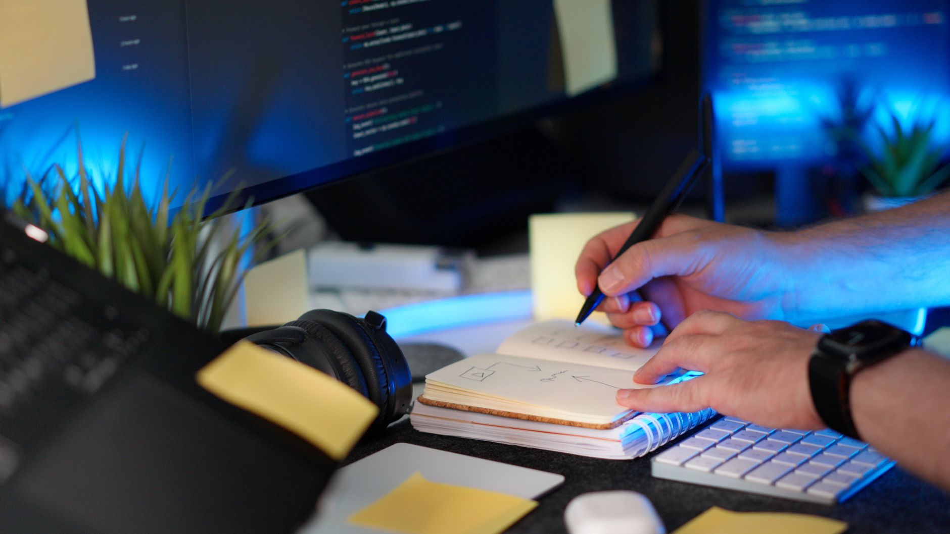 student organizing color-coded notes with laptop and notebook