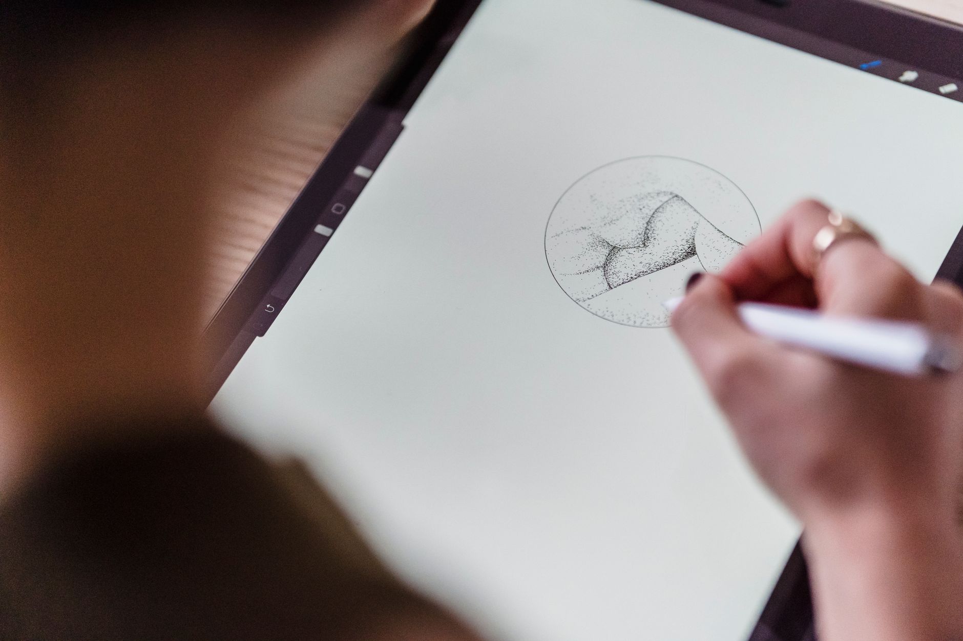 Person creating colorful digital art on a large monitor in a studio