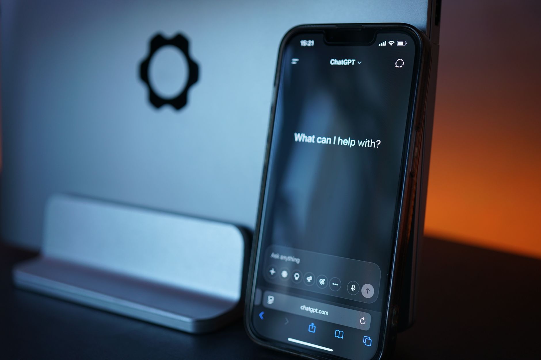 a person typing into an AI assistant on a laptop at a desk