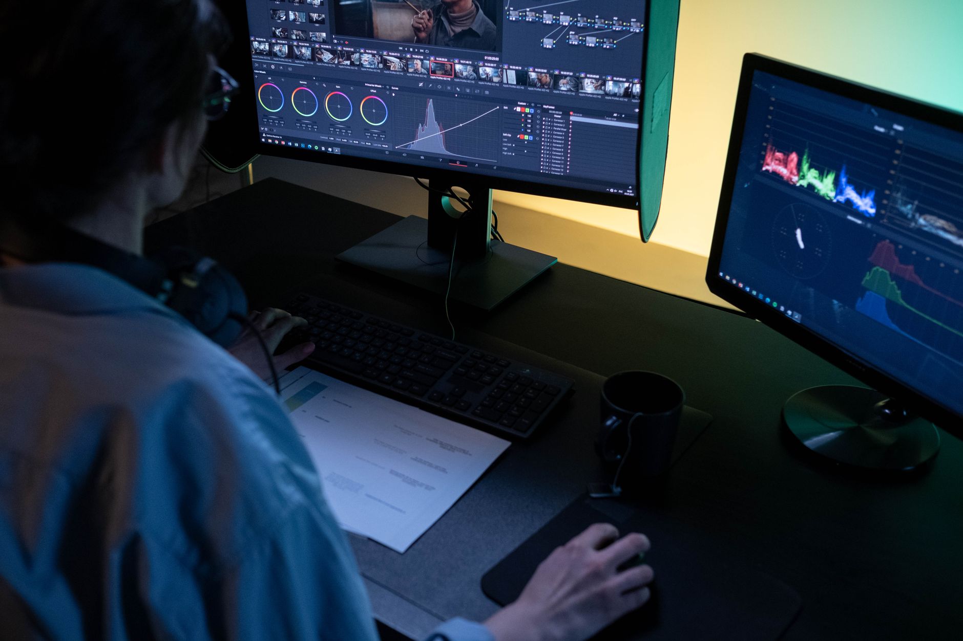A person configuring automation software on dual monitors in an office